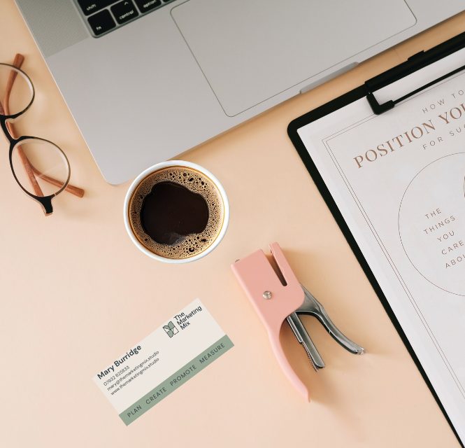 Brand positioning worksheet on a desk with coffee and glasses