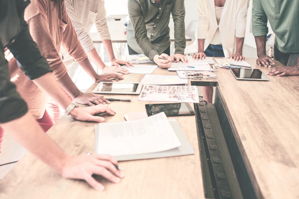 Team reviewing brand materials around a table